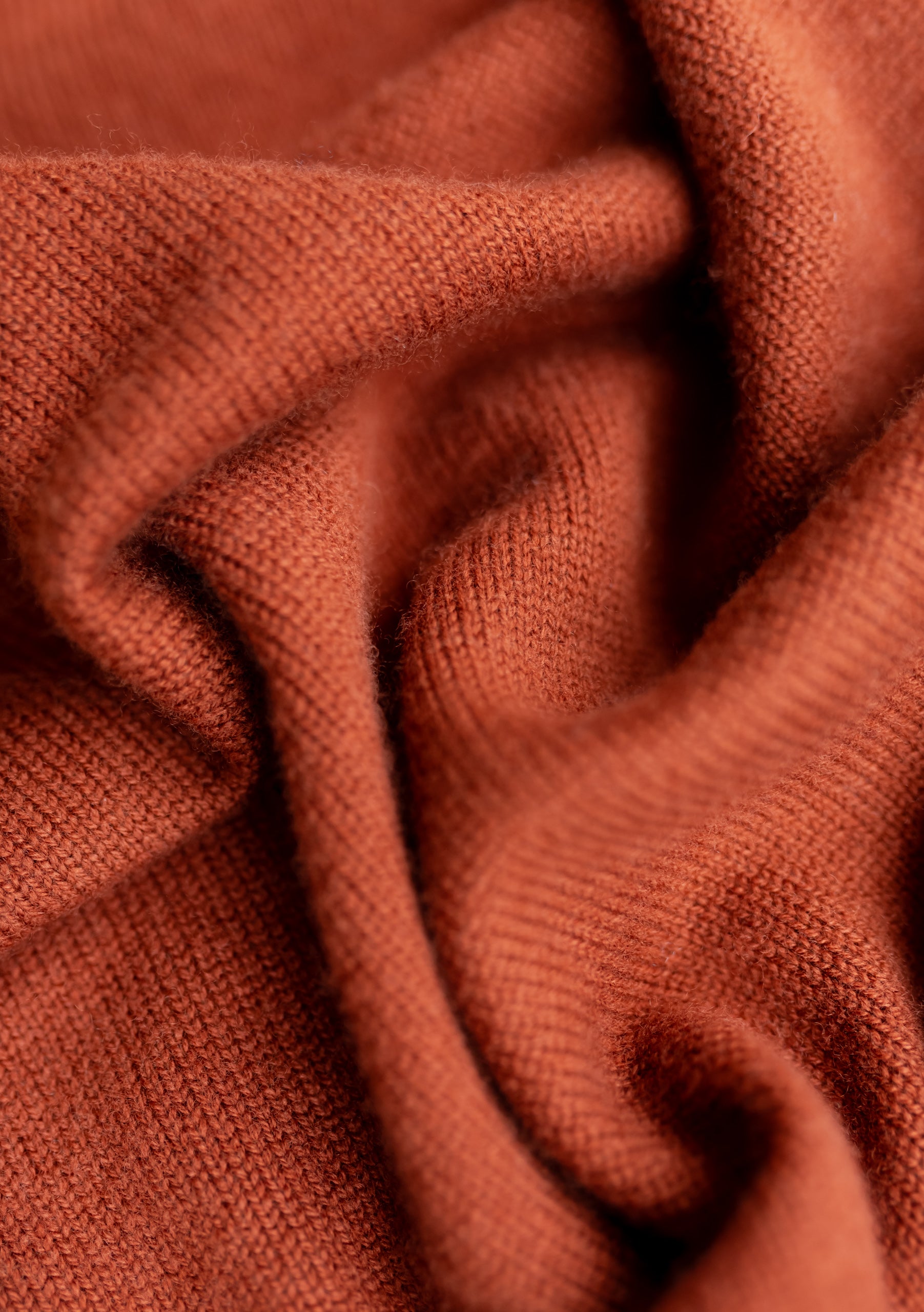 Multi shades of rust, browns and orange. Ladder store rib design. Autumn colors in soft merino wool, quality scarf